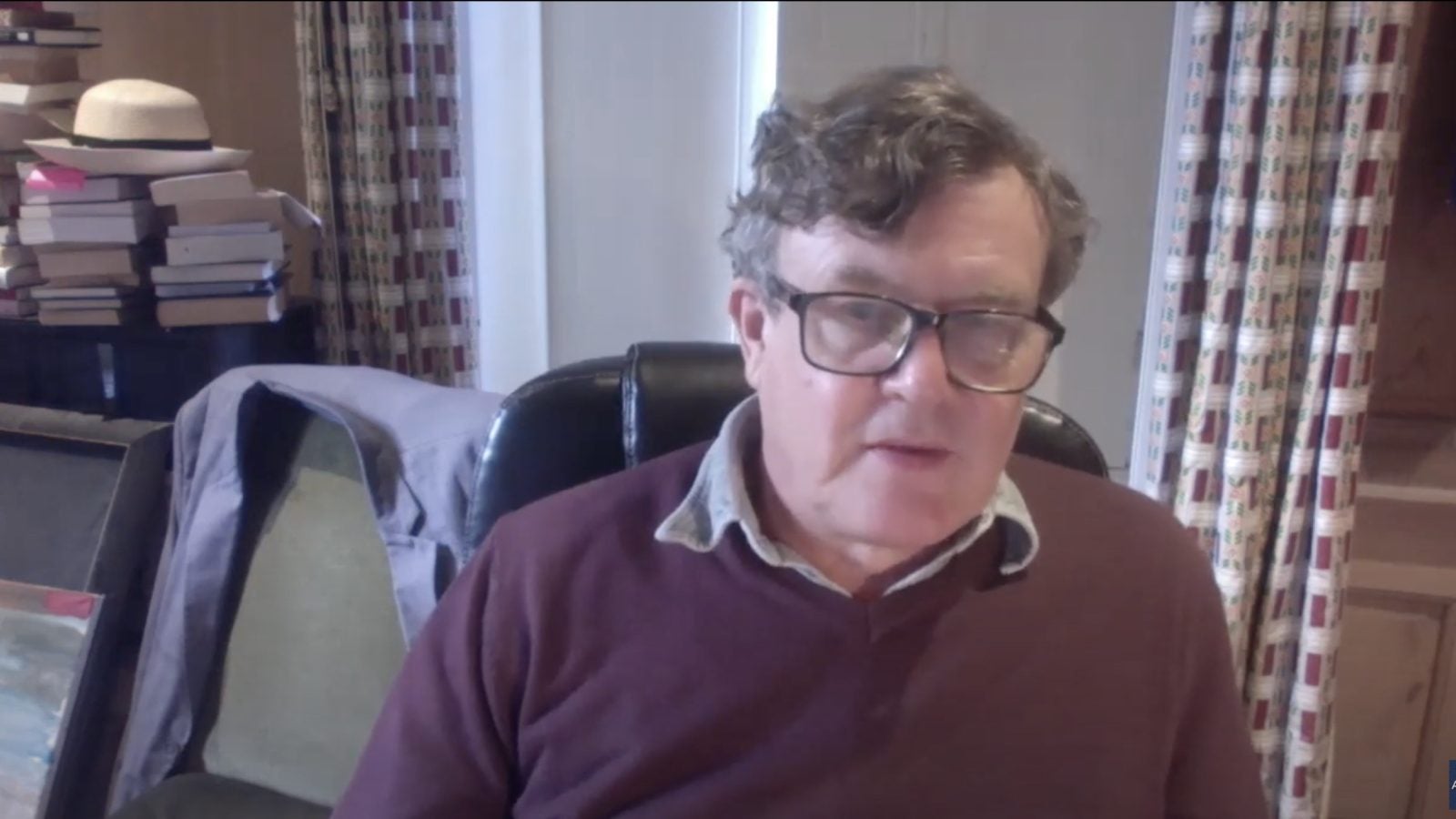 Author Peter Oborne sits in his home office